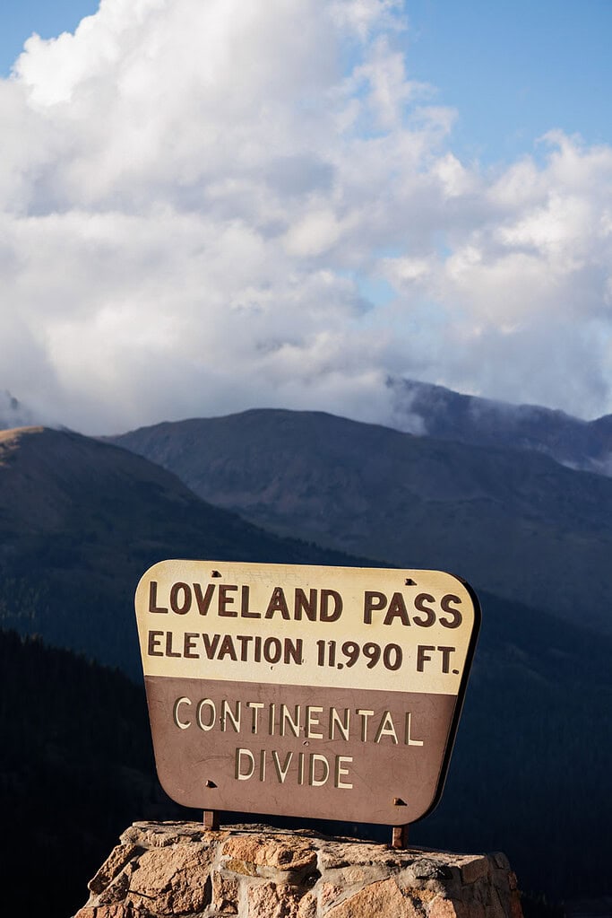 Loveland Pass sign indicating the Continental Divide and elevation of 11,990' above sea level.
