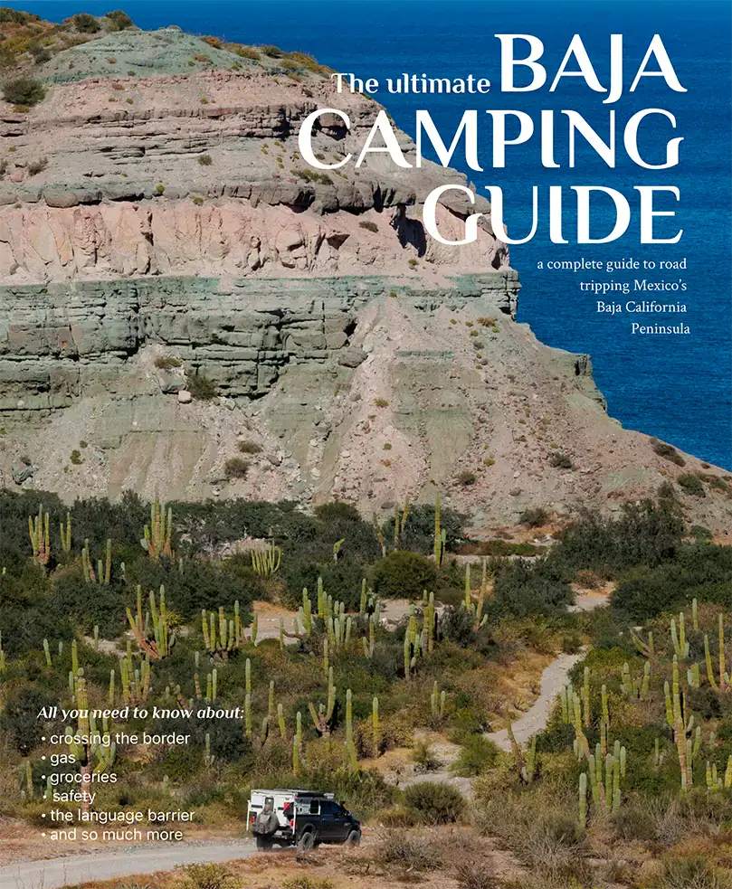 Four Wheel Camper on dirt road, surrounded by cacti, Baja camping guide cover.